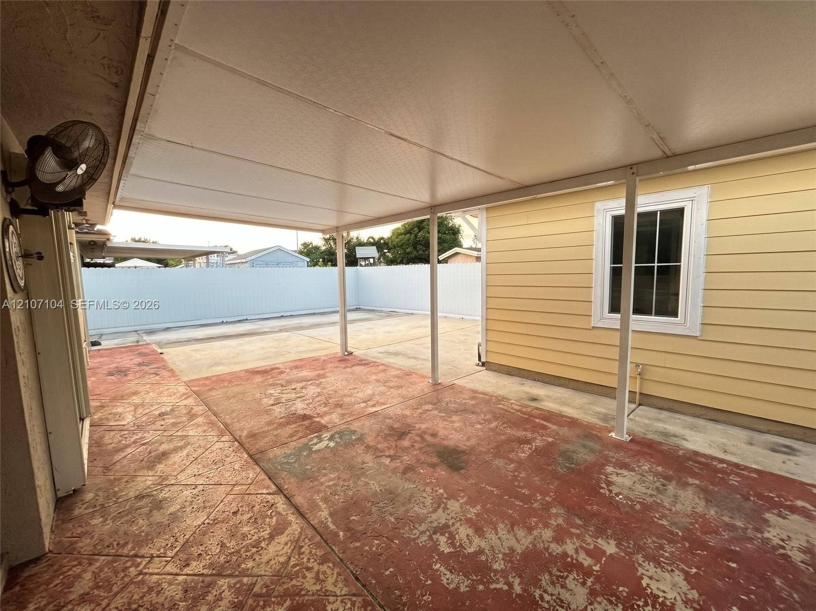 16259 SW 306th Street, #0, Homestead, Homestead, FL 33033 Covered patio featuring stamped concrete flooring, exterior lap siding, and a surrounding privacy fence