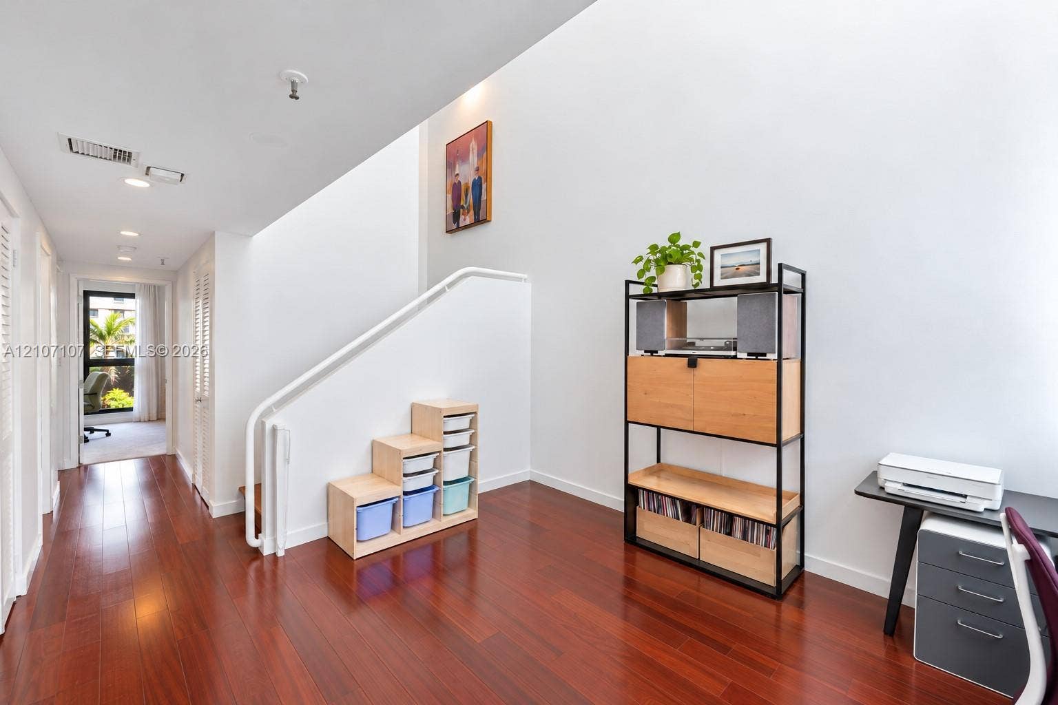 Vaulted ceiling, wood-finish flooring, recessed lighting, and white staircase railing