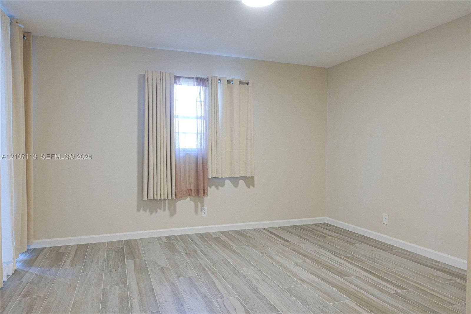 10451 W Broward Boulevard, #102, Plantation, Plantation, FL 33324 Neutral interior featuring wood-finish flooring, light-toned wall paint, and recessed ceiling lighting