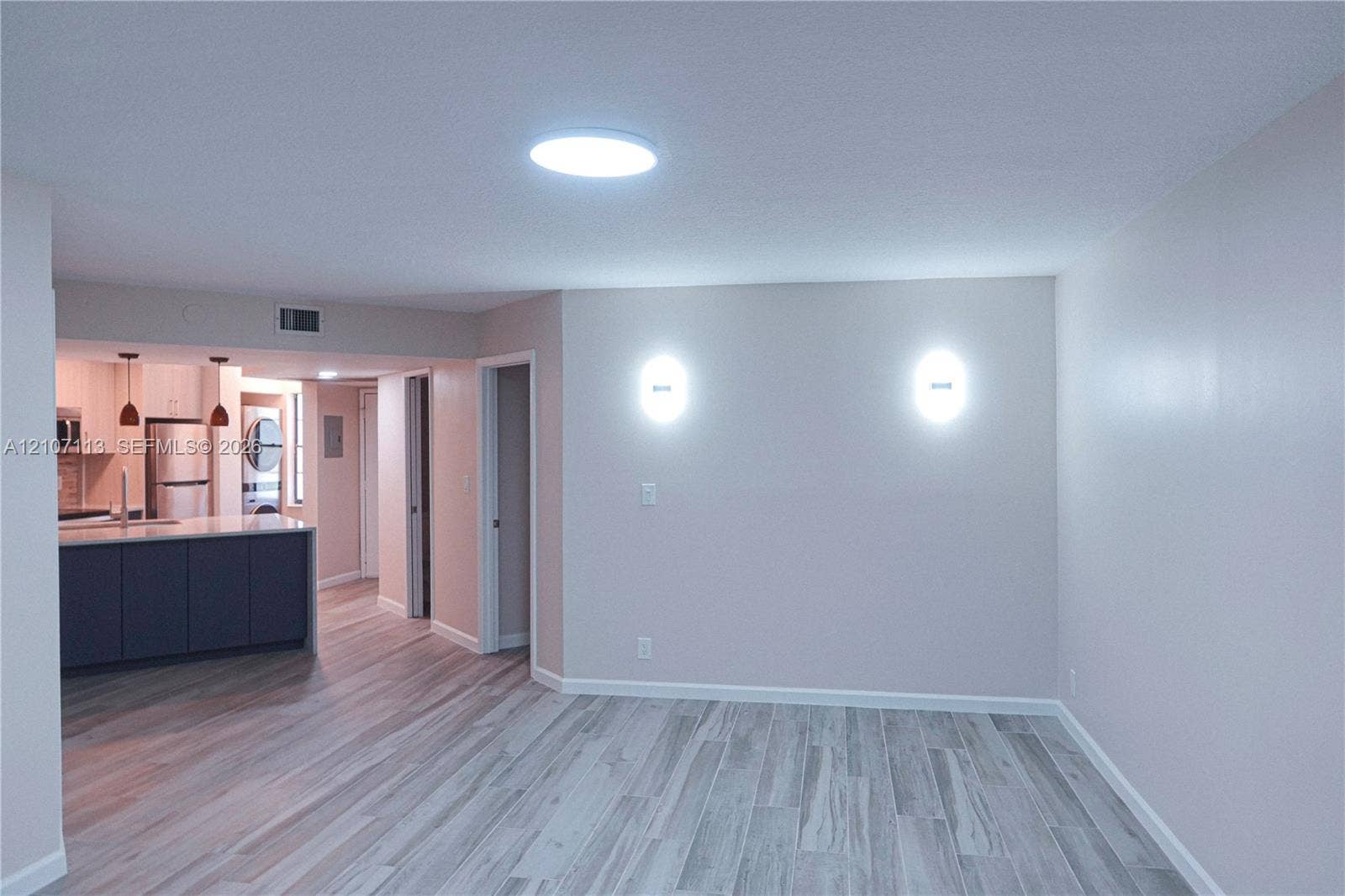 10451 W Broward Boulevard, #102, Plantation, Plantation, FL 33324 Interior space featuring wood-finish flooring, wall-mounted sconce lighting, and a recessed ceiling light