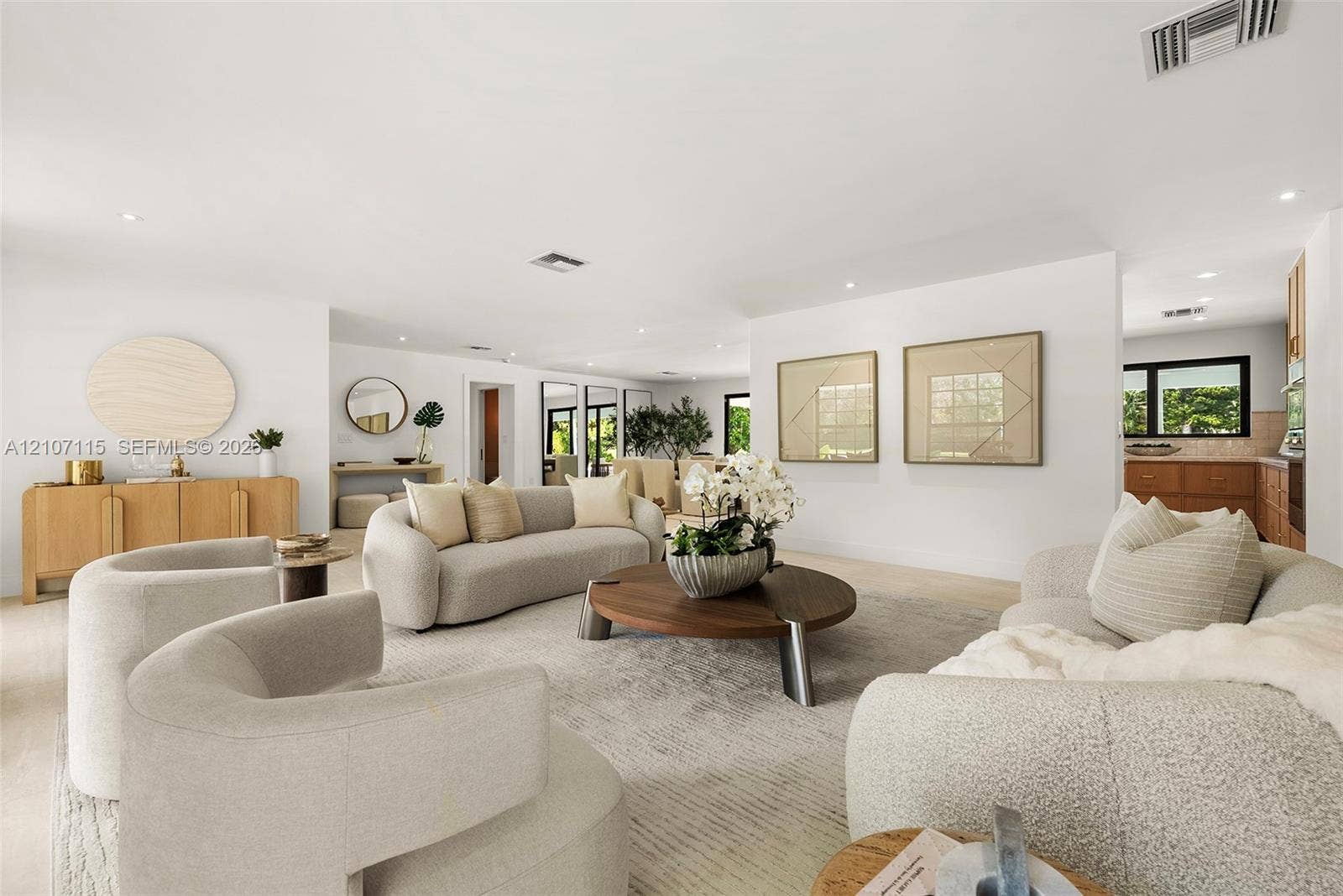 Open floor plan featuring recessed lighting, smooth white walls, light-toned flooring, and neutral finishes