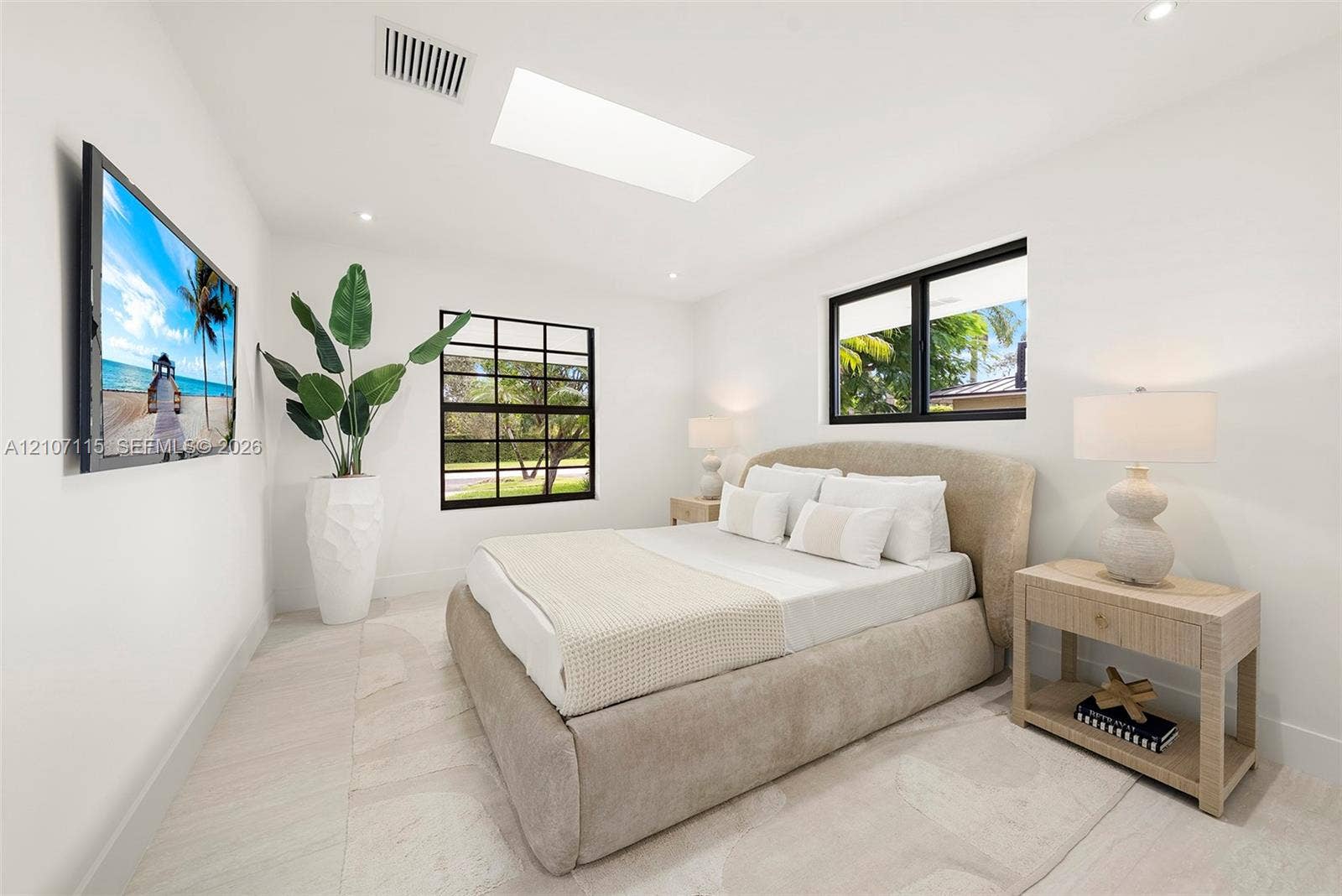 Skylight, large-format tile flooring, and multi-pane windows with black frames