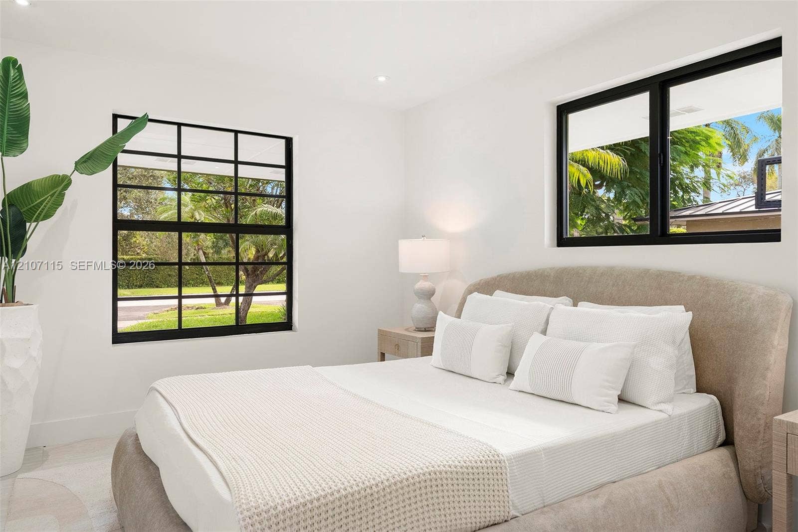 Bedroom 2 Neutral wall finishes, recessed lighting, and black-framed windows featuring multi-pane grids