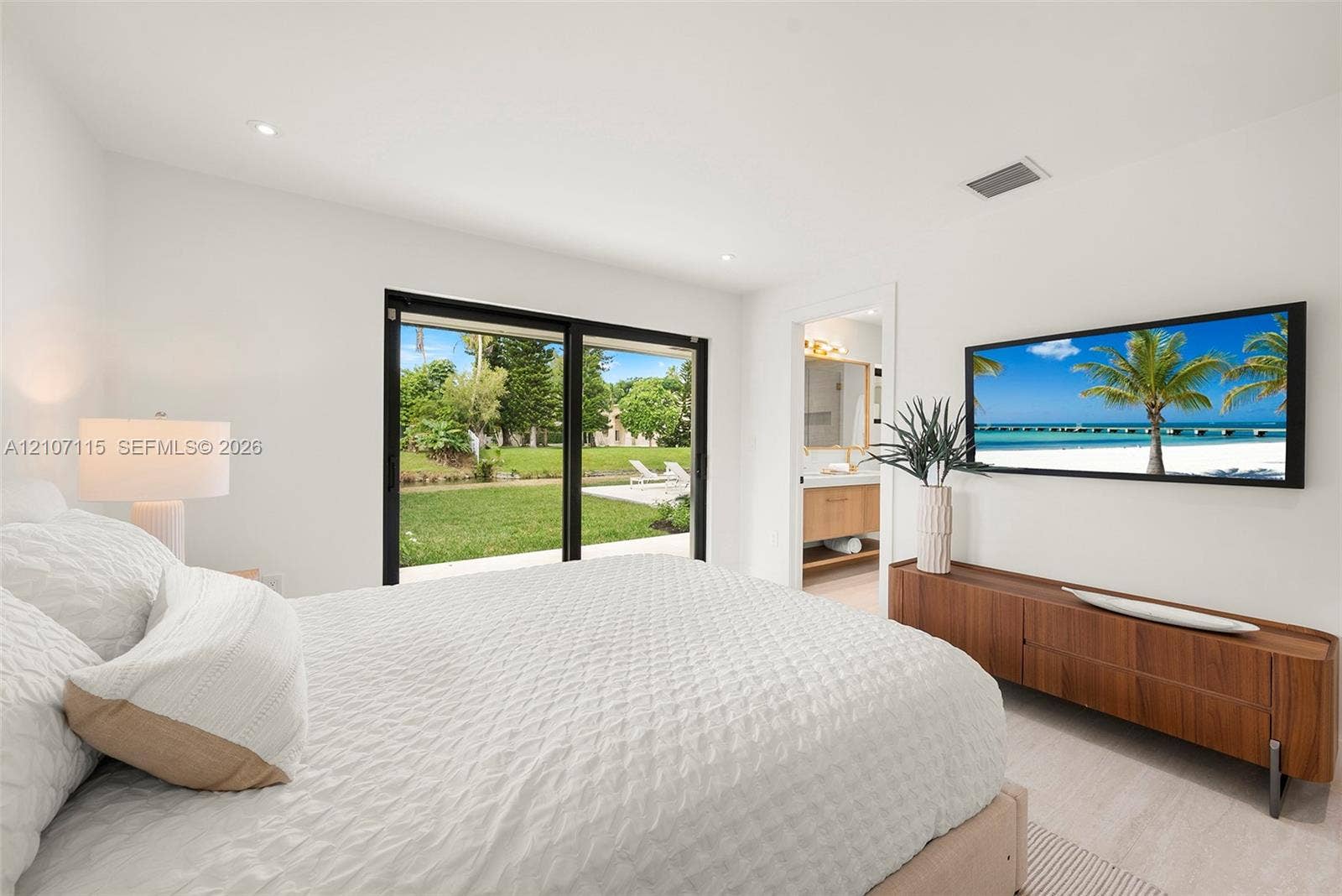 Interior space featuring recessed lighting, light-toned flooring, and black-framed sliding glass doors opening to the outdoors