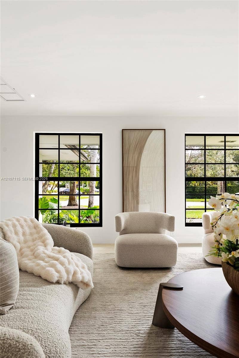 Black-framed multi-pane windows and recessed ceiling lighting