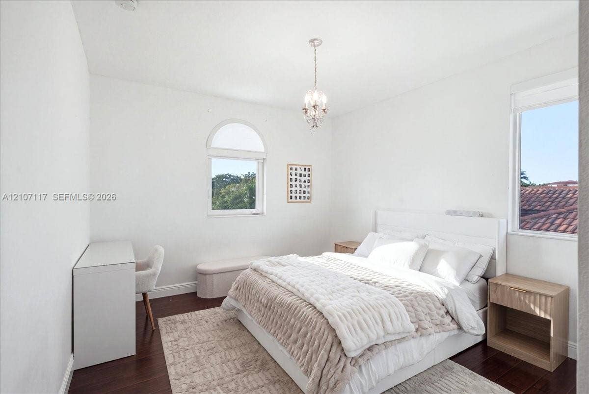 7863 NW 111th Court, Doral, FL 33178 Wood-finish flooring, arched window, and crystal chandelier fixture
