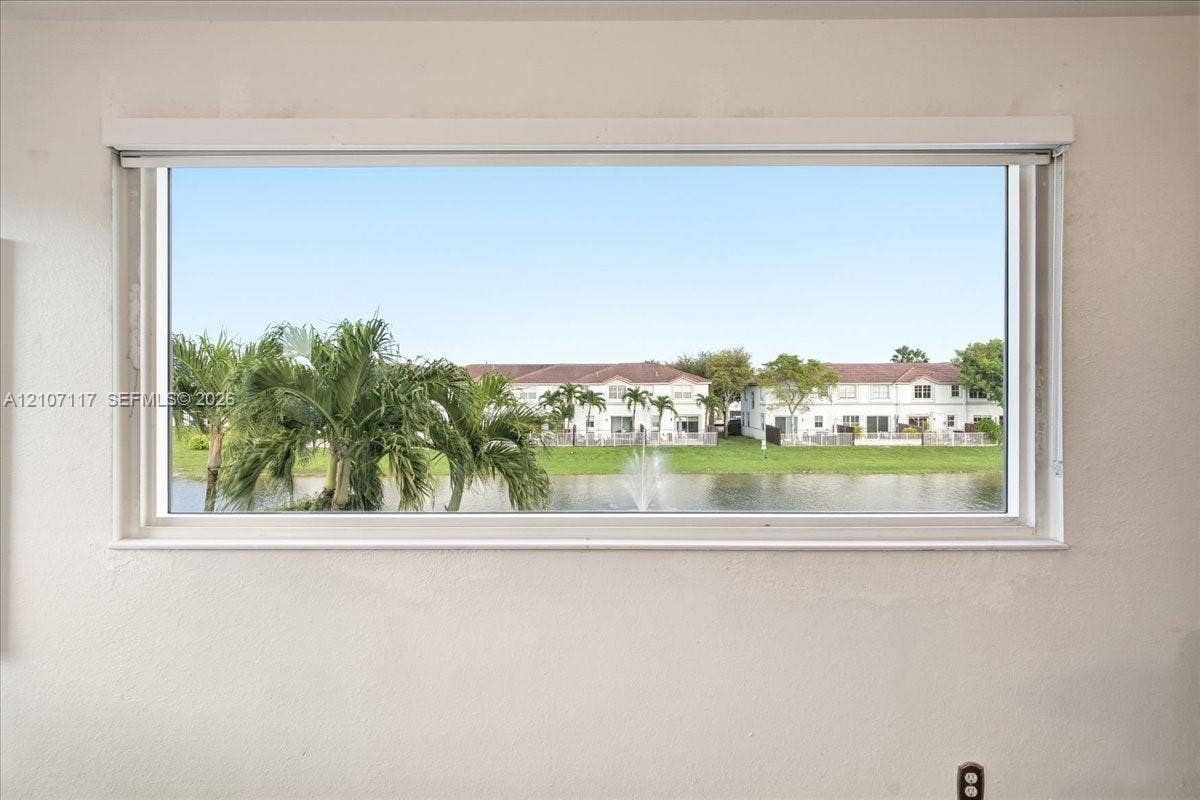 7863 NW 111th Court, Doral, FL 33178 Horizontal window frame featuring a water feature, palm trees, and residential scenery