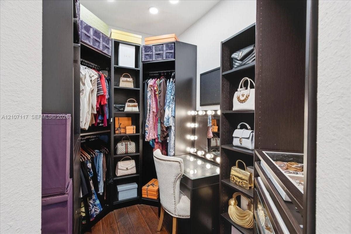 7863 NW 111th Court, Doral, FL 33178 Custom dressing area featuring dark wood-finish cabinetry, built-in shelving, integrated vanity with glass countertop, and recessed ceiling lighting