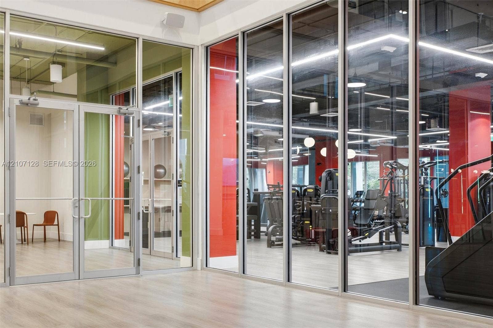 7875 NW 107th Avenue, #802, Doral, Doral, FL 33178 Floor-to-ceiling glass wall partitions with metal framing, wood-finish flooring, exposed ceiling elements, and recessed linear lighting