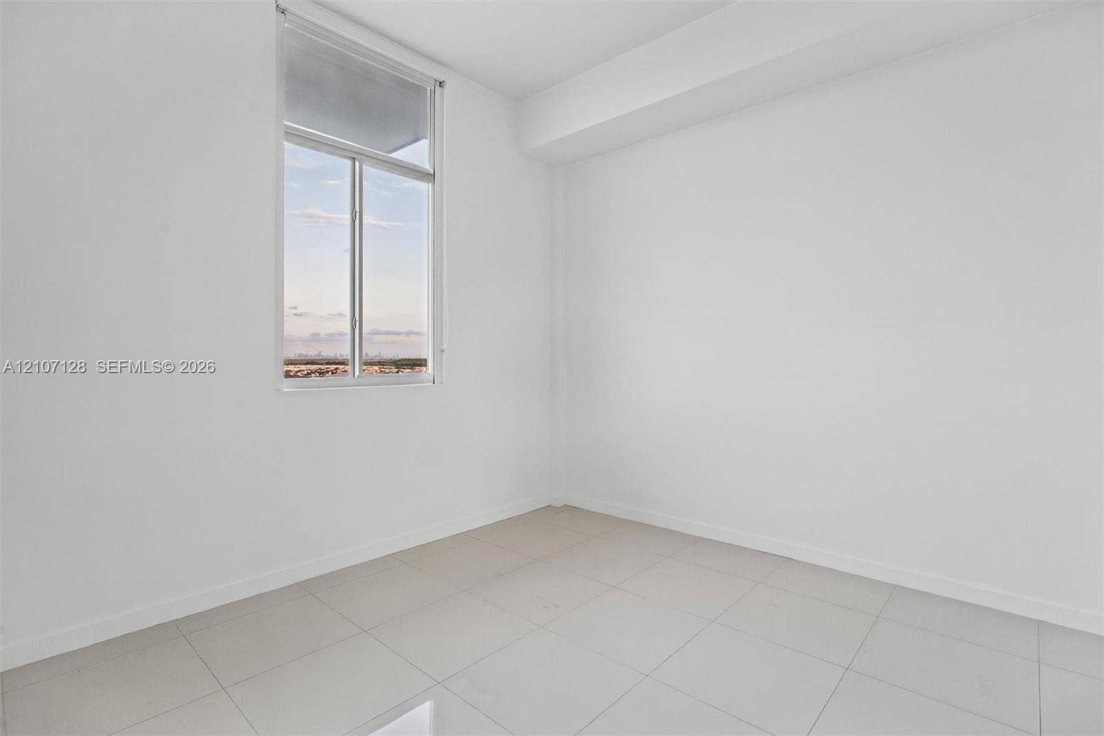 7875 NW 107th Avenue, #802, Doral, Doral, FL 33178 Bedroom featuring high ceilings, light-colored tile flooring, and blackout window treatment