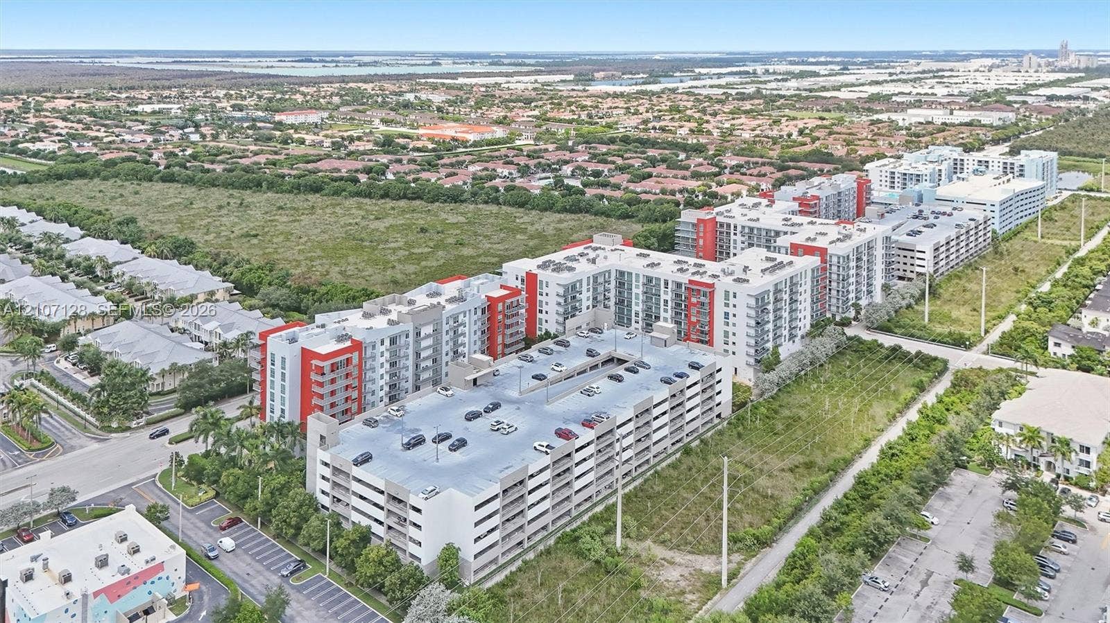 7875 NW 107th Avenue, #802, Doral, Doral, FL 33178 Multi-story residential complex featuring a structured parking garage and balcony units