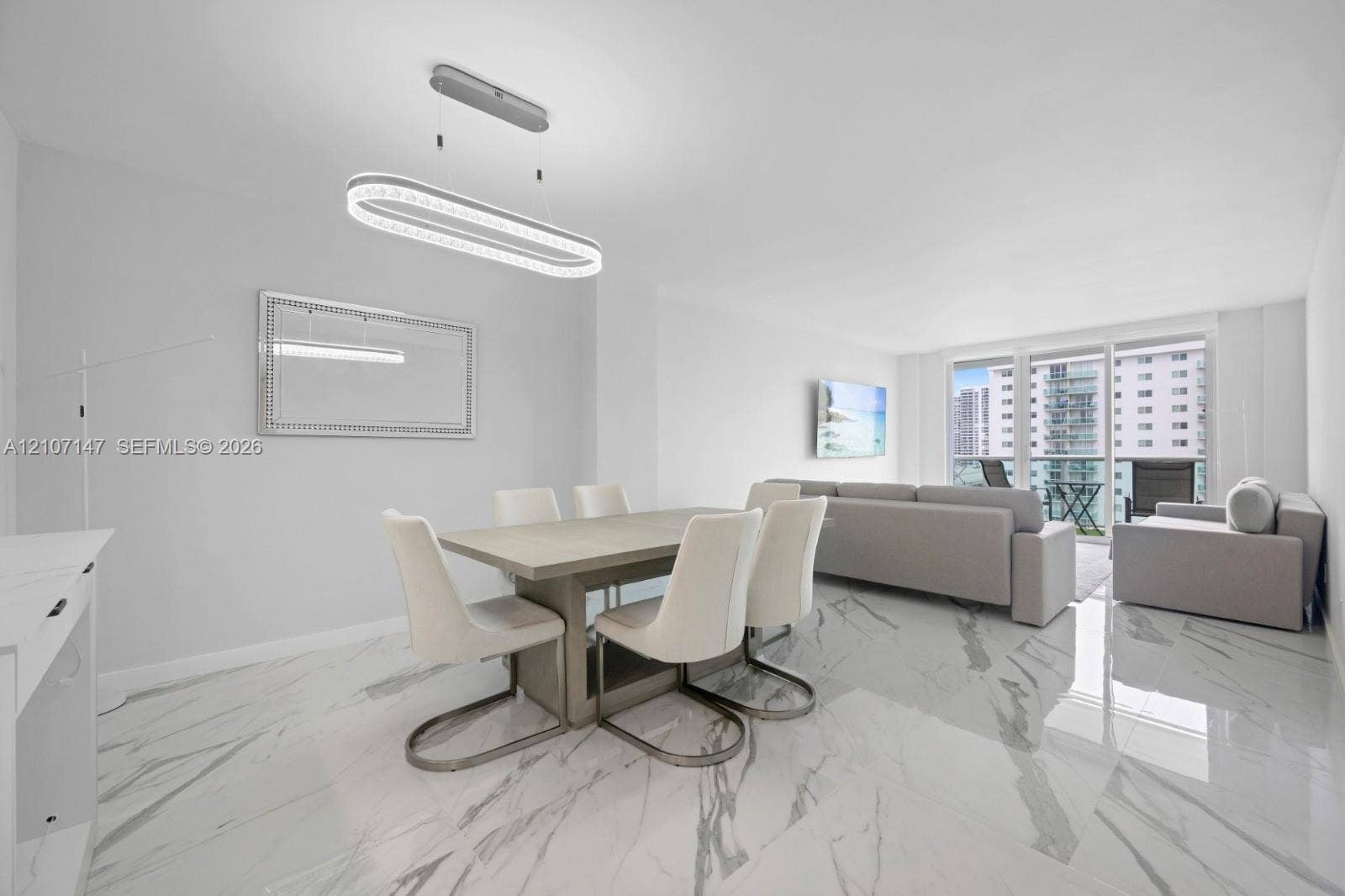 Polished stone-finish flooring, modern oval LED pendant lighting, and full-height glass balcony doors