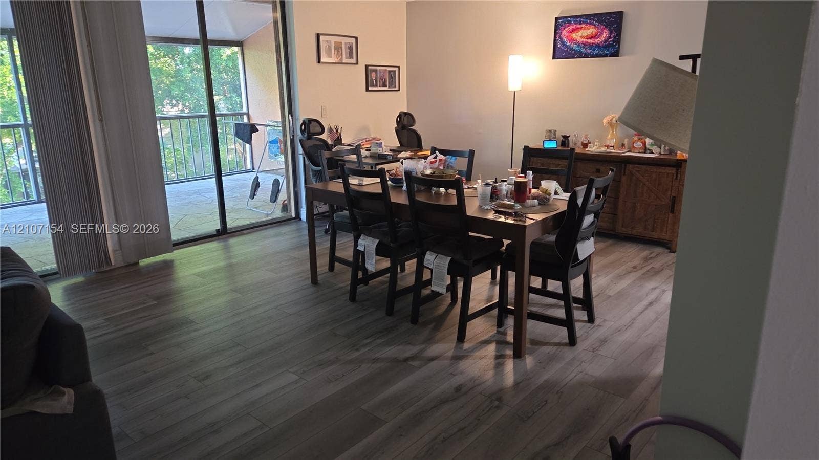 450 Commodore Drive, #311, Plantation, FL 33325 Wood-finish flooring, sliding glass patio door, and metal balcony railing
