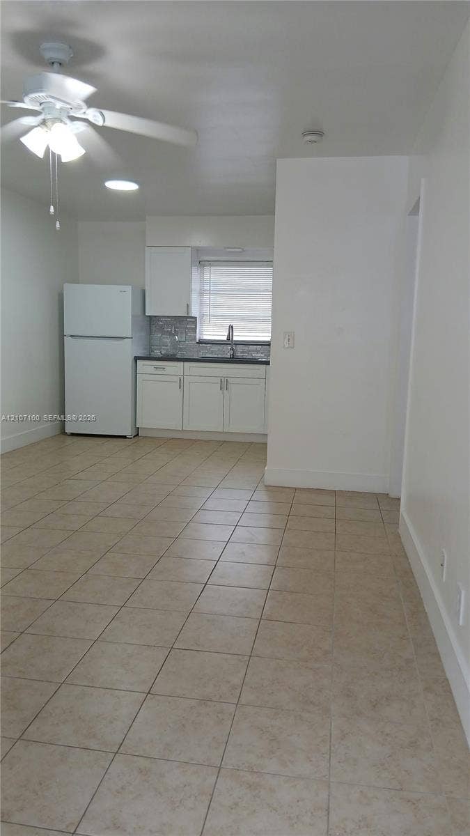 325 NE 2nd Street, #2, Hallandale Beach, Hallandale Beach, FL 33009 Kitchen featuring white cabinetry, tile flooring, built-in refrigerator, recessed lighting, and a ceiling fan