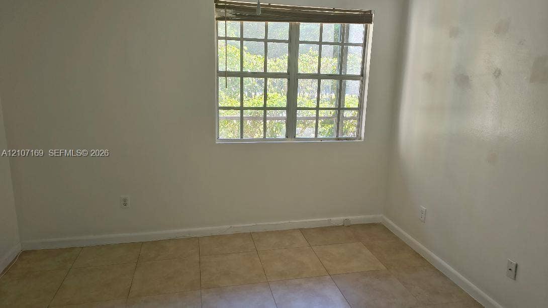 1267 SW 46th Avenue, #2311, Pompano Beach, Pompano Beach, FL 33069 Interior space featuring a multi-pane grid window and large-format tile flooring