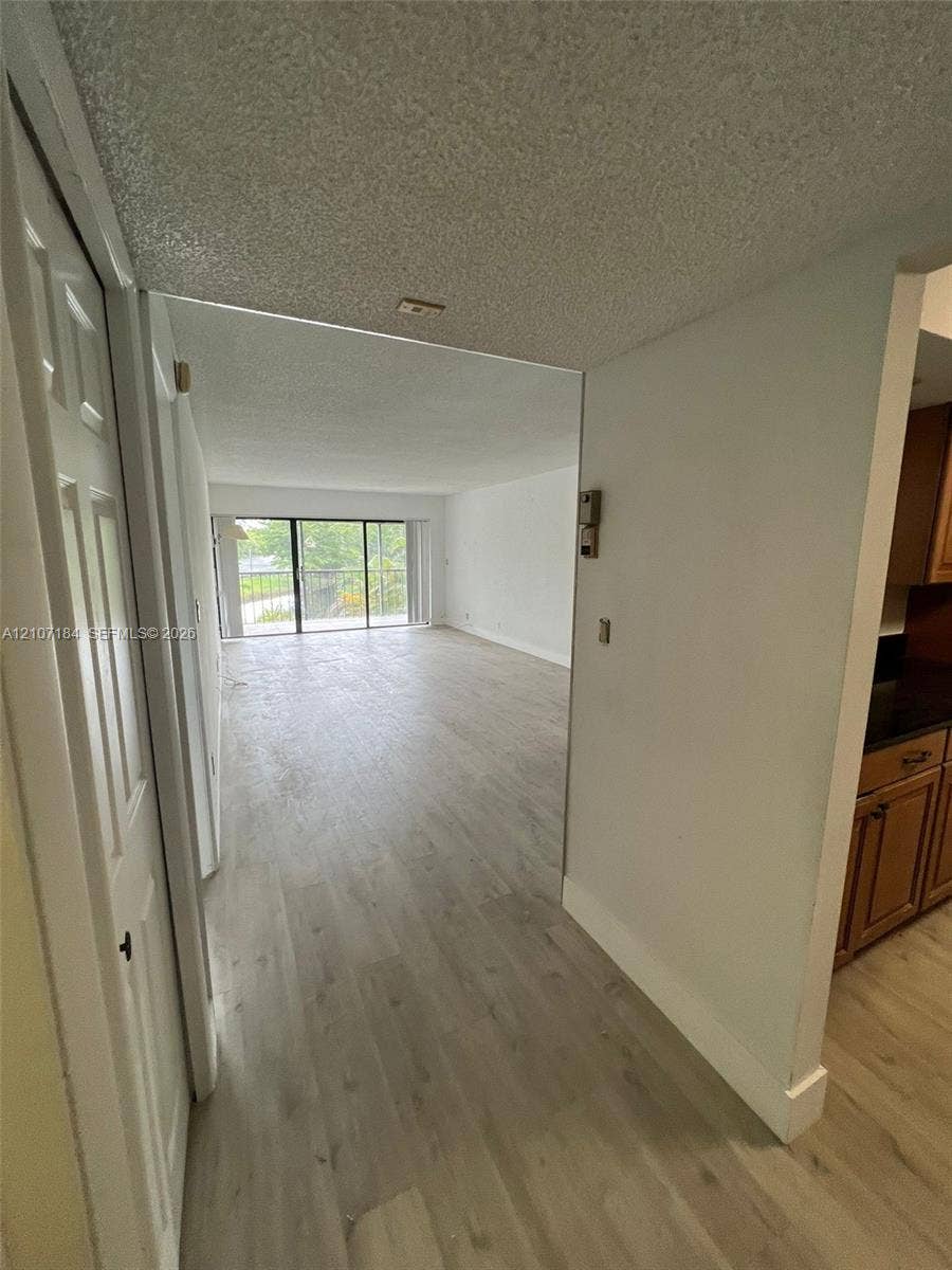 240 Lakeview Drive, #209, Weston, Weston, FL 33326 Open-concept floor plan featuring wood-finish flooring, floor-to-ceiling sliding glass doors, and recessed lighting