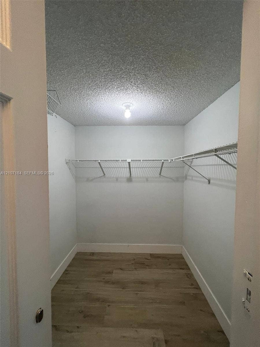 240 Lakeview Drive, #209, Weston, Weston, FL 33326 Walk-in closet featuring wood-finish flooring and installed wire shelving
