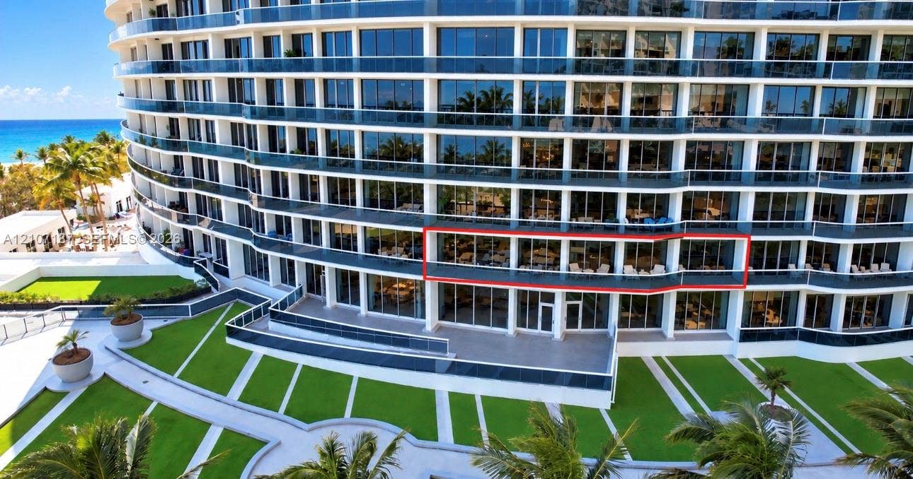 9601 Collins Avenue, #403, Bal Harbour, FL 33154 Multi-story glass-facade residential building featuring expansive private balconies, floor-to-ceiling windows, and manicured landscaping