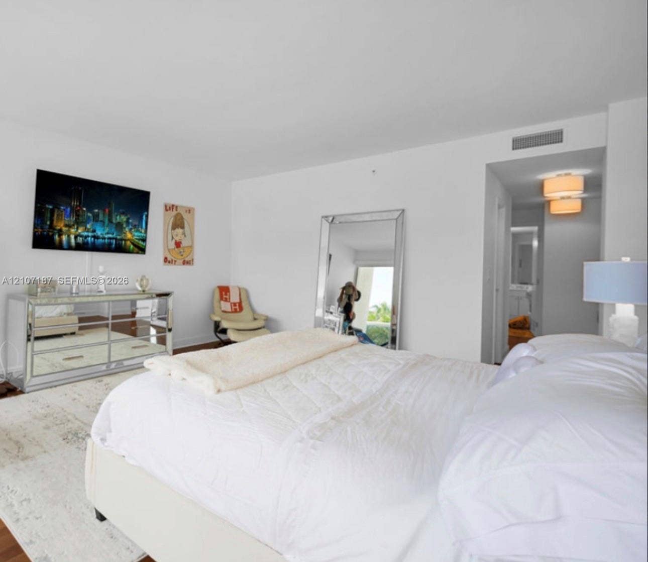 9601 Collins Avenue, #403, Bal Harbour, FL 33154 Neutral-toned interior space featuring wood-finish flooring, crisp white walls, and a recessed ceiling lighting fixture