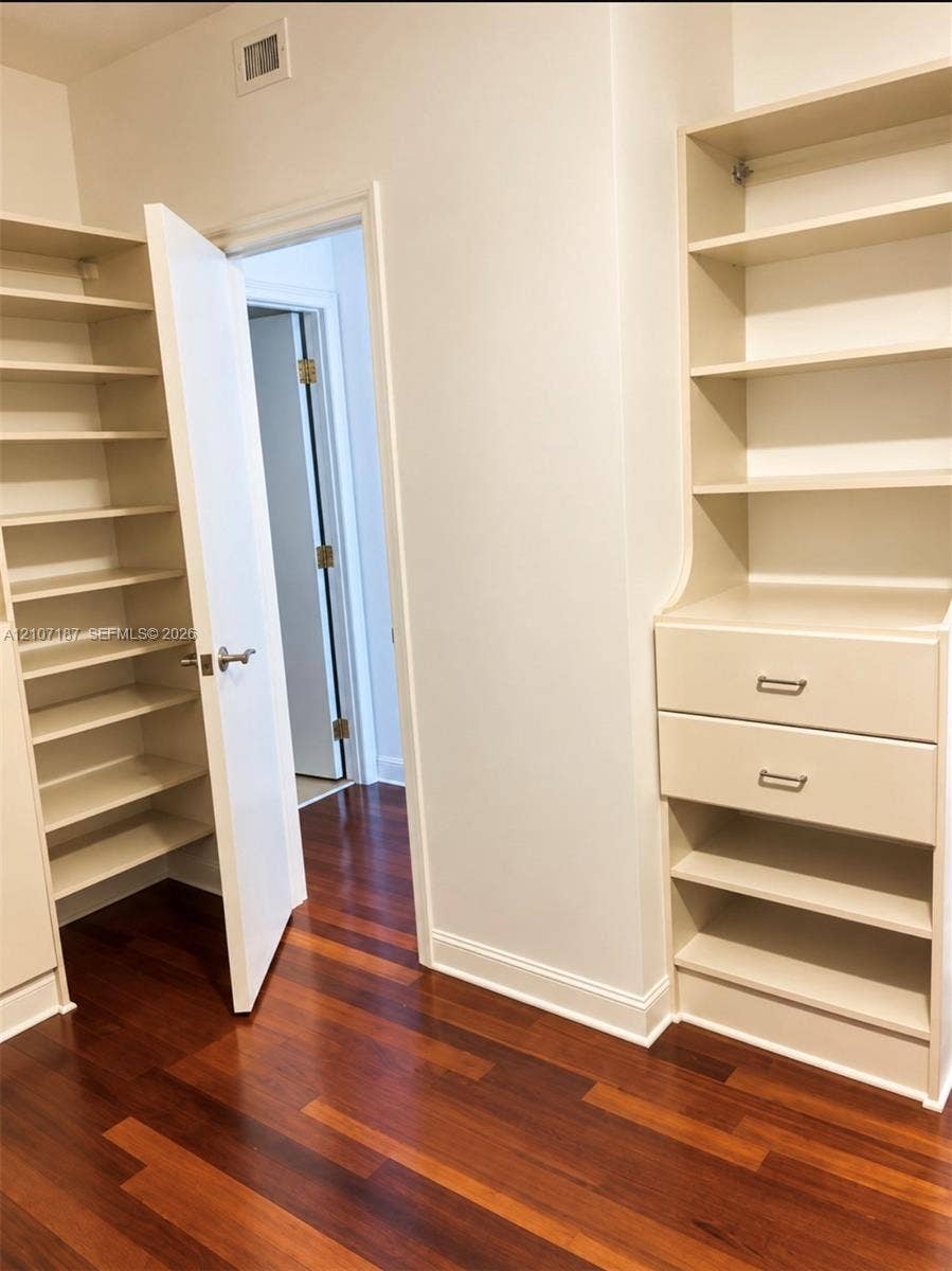 9601 Collins Avenue, #403, Bal Harbour, FL 33154 Custom built-in storage with adjustable shelving, two integrated drawers, and wood-finish flooring