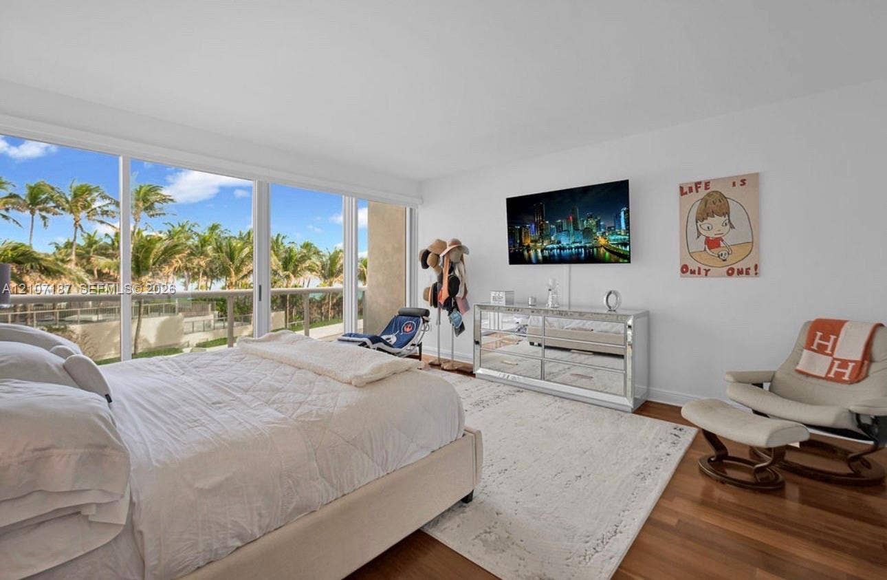 9601 Collins Avenue, #403, Bal Harbour, FL 33154 Floor-to-ceiling sliding glass panels, balcony access, wood-finish flooring, and expansive natural light