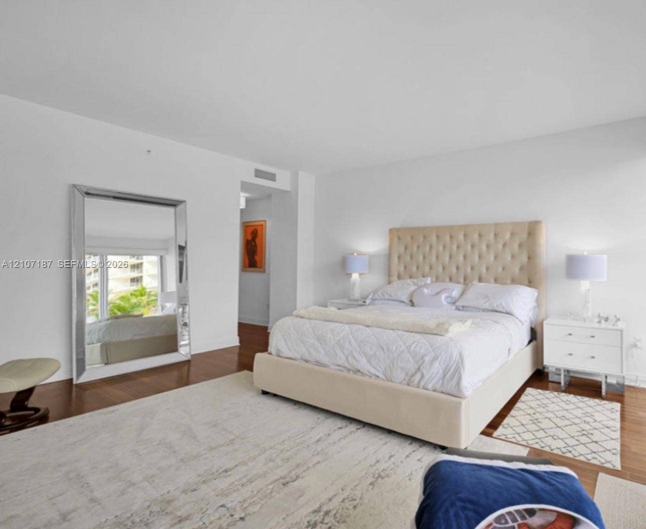 9601 Collins Avenue, #403, Bal Harbour, FL 33154 Bedroom featuring wood-finish flooring, smooth-finish ceilings, and expansive glass paneled window