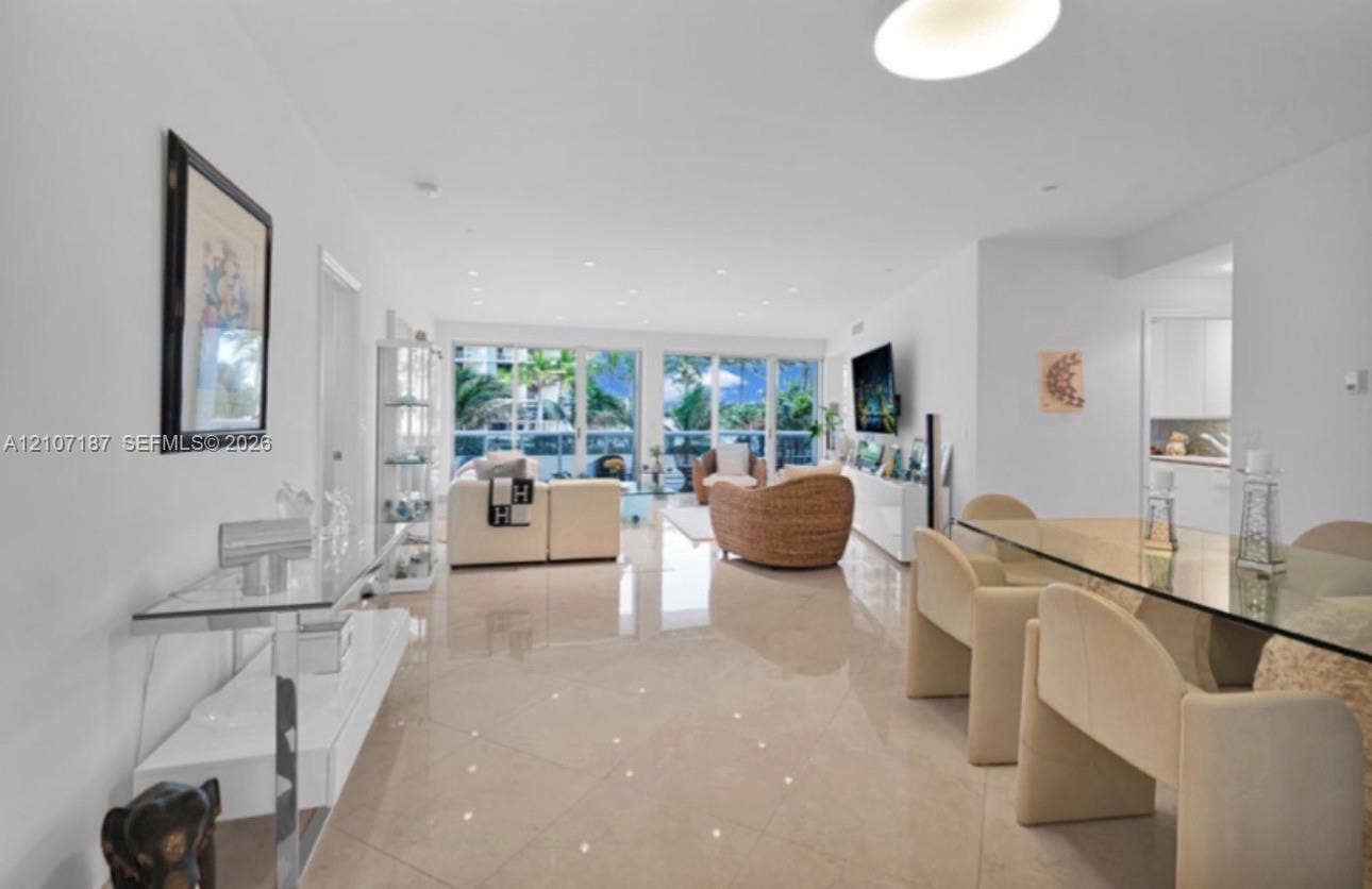 9601 Collins Avenue, #403, Bal Harbour, FL 33154 Open-concept interior featuring large-format polished tile flooring, recessed ceiling lighting, and floor-to-ceiling glass sliding doors
