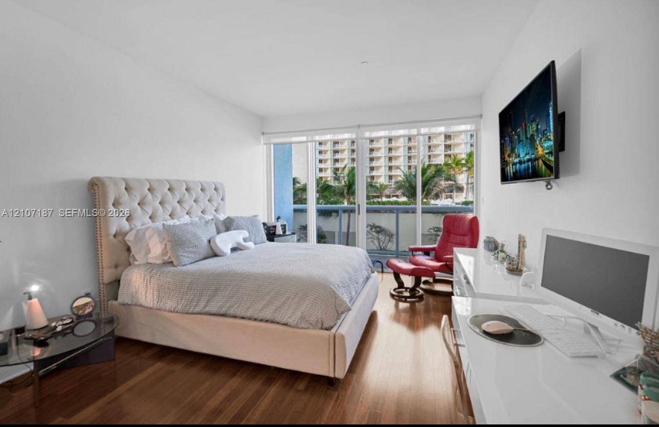 9601 Collins Avenue, #403, Bal Harbour, FL 33154 Floor-to-ceiling sliding glass doors, wood-finish flooring, and recessed ceiling lighting
