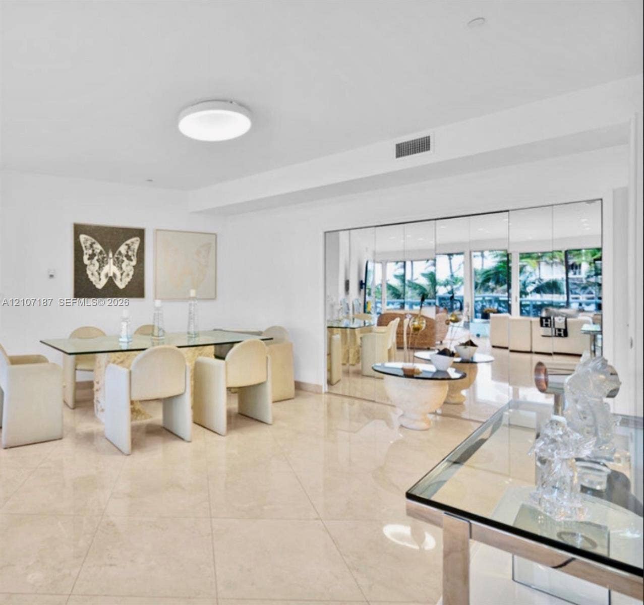 9601 Collins Avenue, #403, Bal Harbour, FL 33154 Large-format stone tile flooring, expansive floor-to-ceiling mirrored walls, and recessed ceiling lighting