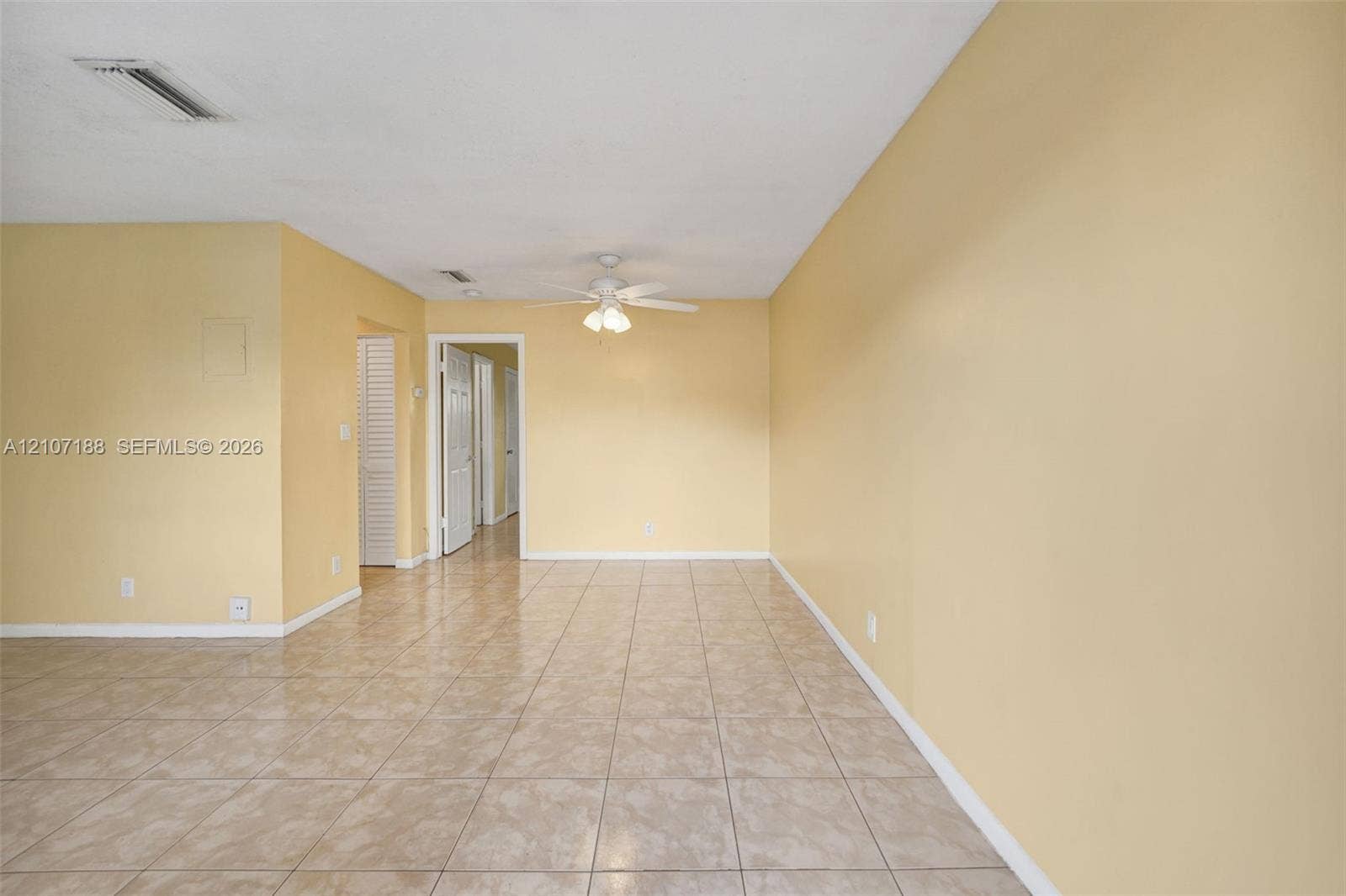 10301 NW 36th Street, #2, Coral Springs, Coral Springs, FL 33065 Interior space featuring neutral-toned walls, tile flooring, and a ceiling fan with integrated lighting