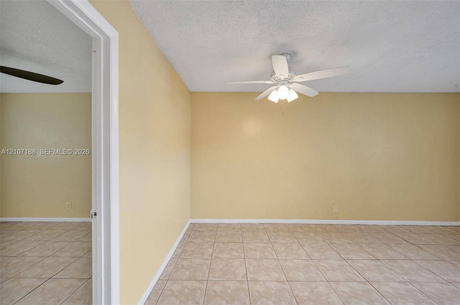 10301 NW 36th Street, #2, Coral Springs, Coral Springs, FL 33065 Room featuring ceramic tile flooring, a center-mounted ceiling fan with integrated lighting, and a white door frame