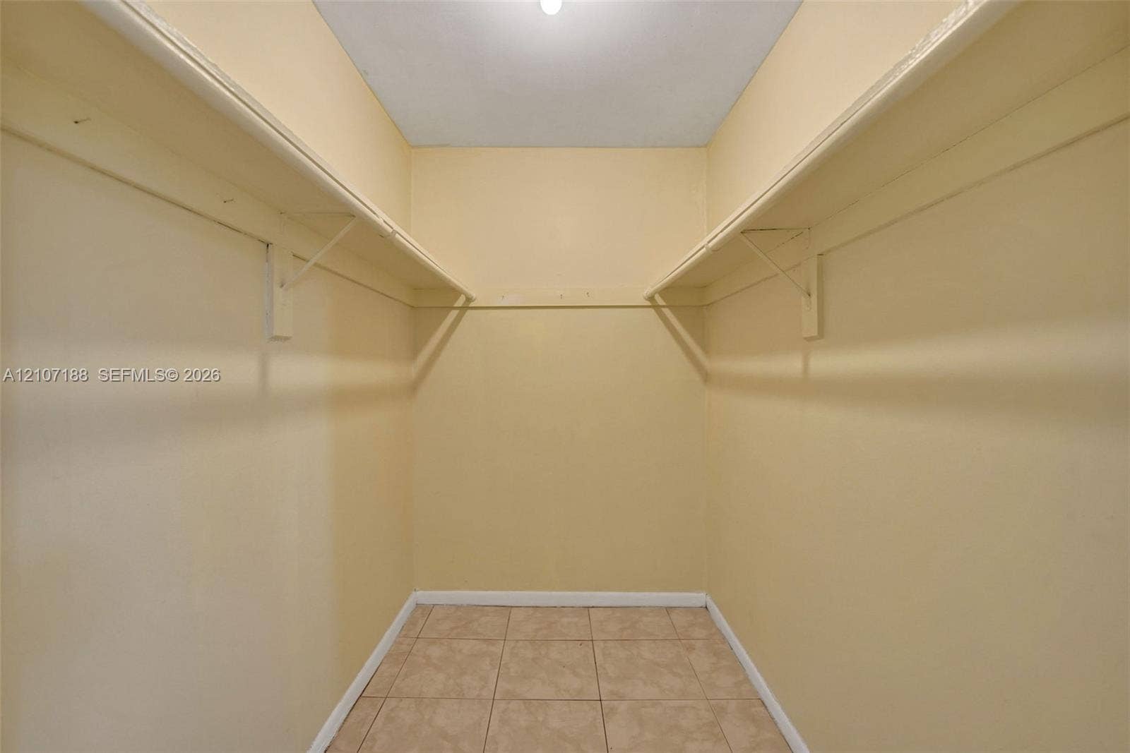 10301 NW 36th Street, #2, Coral Springs, Coral Springs, FL 33065 Walk-in storage space featuring built-in shelving, hanging rods, and tile flooring