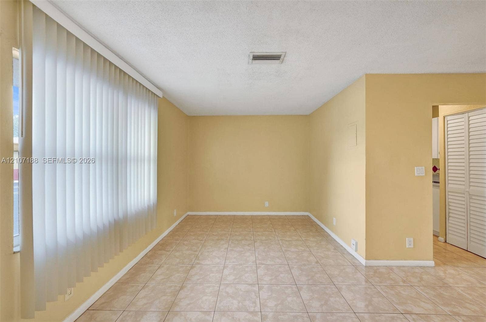10301 NW 36th Street, #2, Coral Springs, Coral Springs, FL 33065 Tile flooring, vertical window blinds, and louvered closet doors