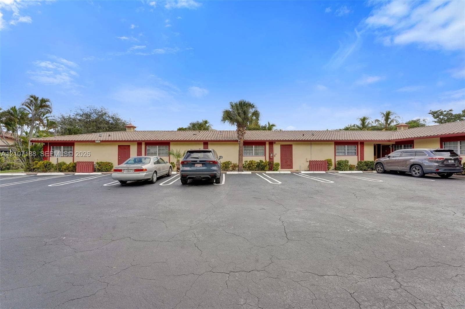 10301 NW 36th Street, #2, Coral Springs, Coral Springs, FL 33065 Single-story exterior featuring a tile roof, painted stucco facade, and designated off-street parking