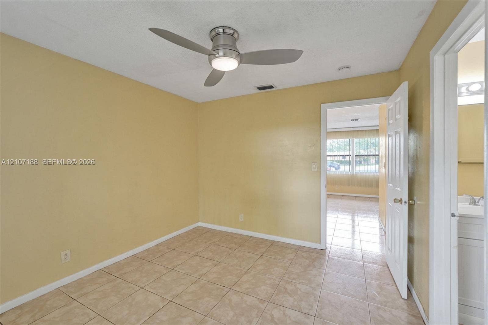 10301 NW 36th Street, #2, Coral Springs, Coral Springs, FL 33065 Room featuring neutral wall paint, tile flooring, and a modern brushed-nickel ceiling fan with integrated lighting
