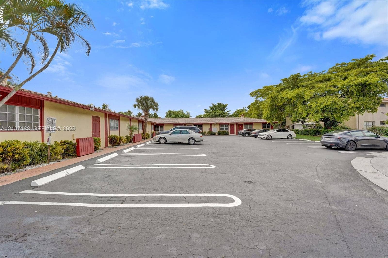 10301 NW 36th Street, #2, Coral Springs, Coral Springs, FL 33065 Single-story exterior featuring a tile roof, dedicated parking spaces, and mature landscaping