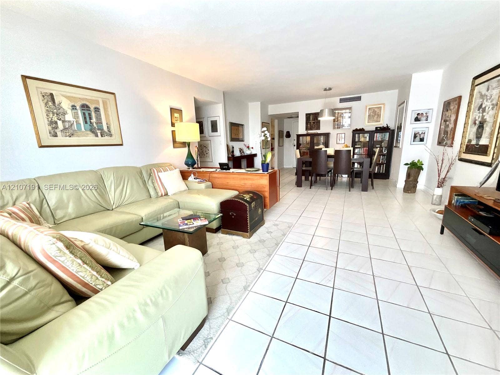 Open-concept interior featuring white tiled flooring throughout and recessed ceiling lighting