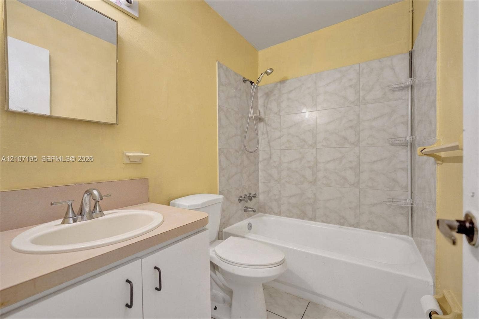 10301 NW 36th Street, #5, Coral Springs, Coral Springs, FL 33065 Bathroom featuring a white vanity cabinet with a solid surface countertop, integrated sink with chrome faucet, tub-shower combination with tile surround, and a wall-mounted mirror