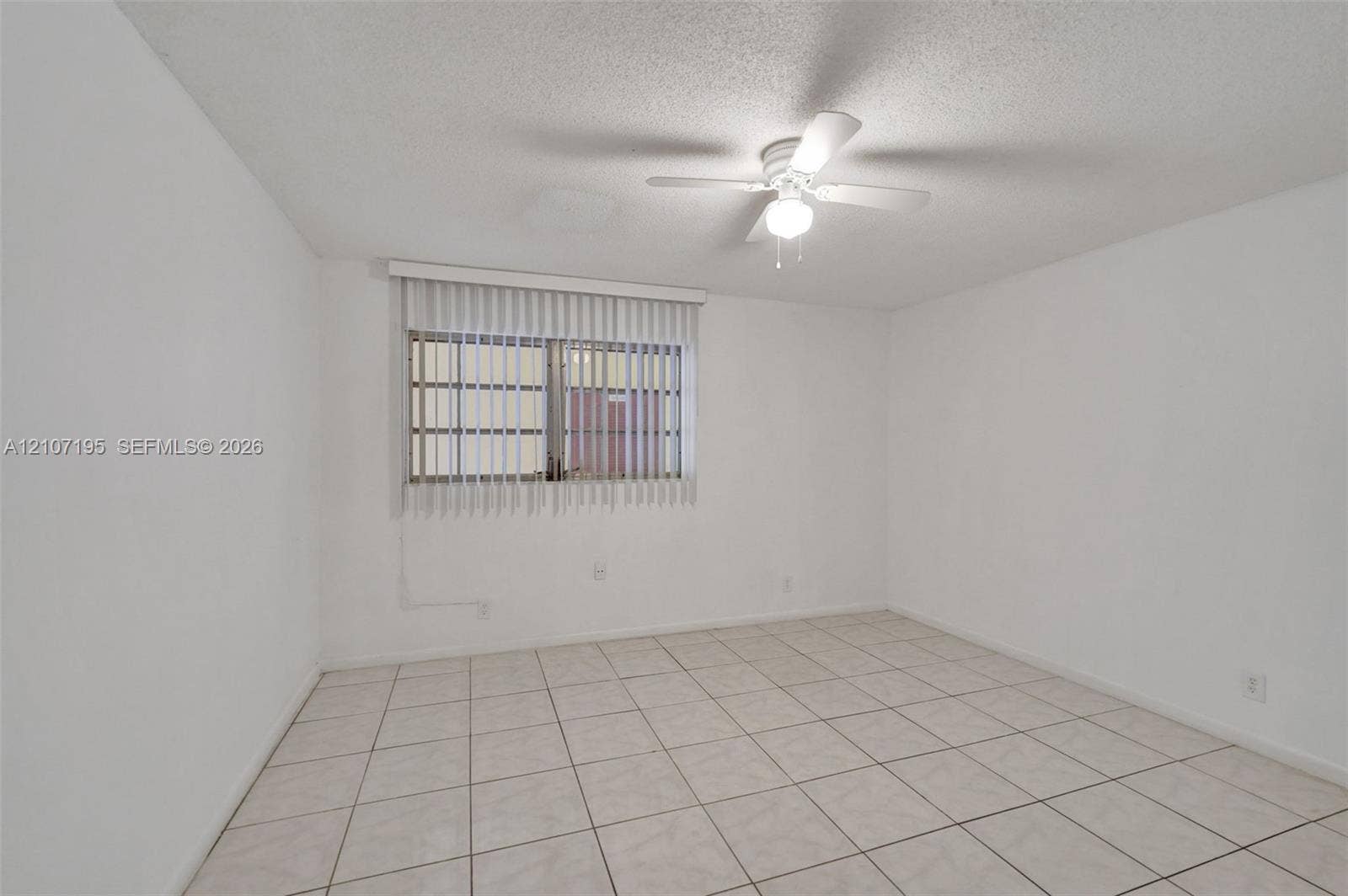 10301 NW 36th Street, #5, Coral Springs, Coral Springs, FL 33065 Neutral-toned tile flooring, ceiling fan with integrated lighting, and vertical window blinds