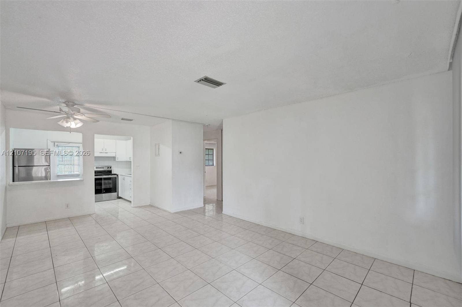 10301 NW 36th Street, #5, Coral Springs, Coral Springs, FL 33065 Interior space featuring light-toned tile flooring, recessed ceiling lighting, and a white ceiling fan