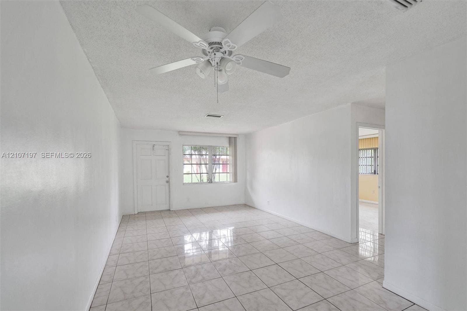 10301 NW 36th Street, #6, Coral Springs, Coral Springs, FL 33065 Interior space featuring tile flooring, a multi-blade ceiling fan with integrated lighting, and a multi-pane window