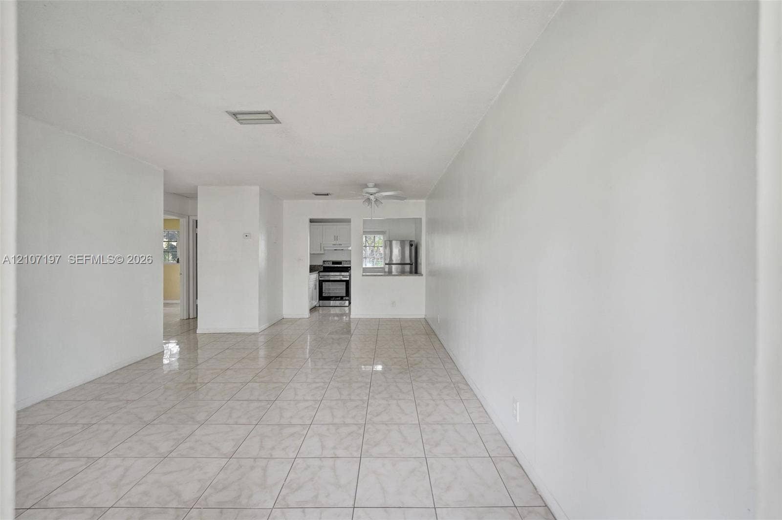 10301 NW 36th Street, #6, Coral Springs, Coral Springs, FL 33065 Interior space featuring neutral wall tones, large-format tile flooring, and a ceiling-mounted fan