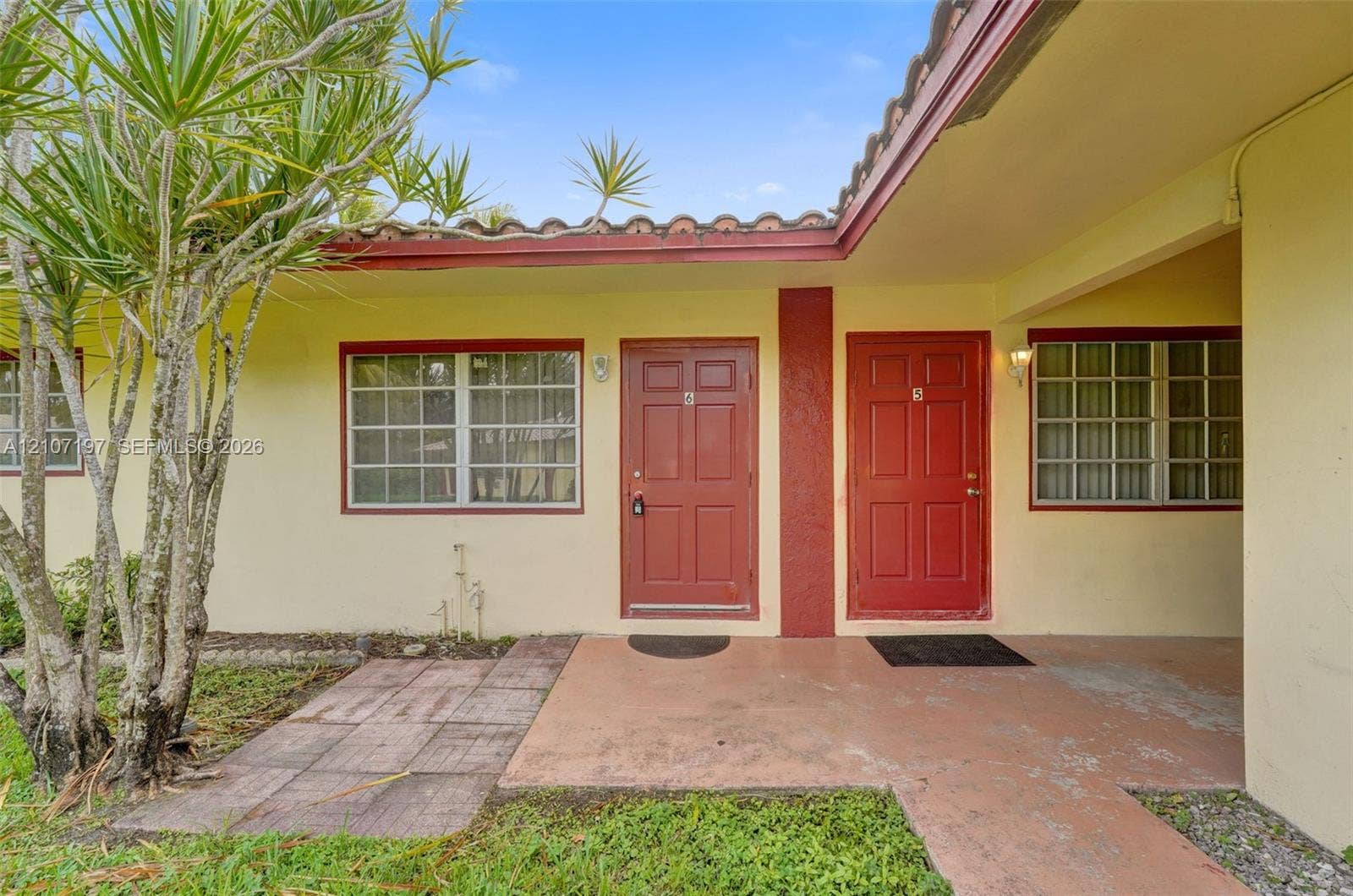 10301 NW 36th Street, #6, Coral Springs, Coral Springs, FL 33065 Stucco exterior featuring clay tile roofing, concrete walkway, and double entry doors with grid-pattern windows