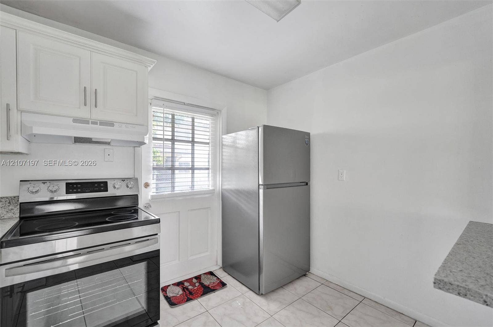 10301 NW 36th Street, #6, Coral Springs, Coral Springs, FL 33065 Kitchen featuring white cabinetry, stainless steel electric range with hood, stone-finish countertops, and light-toned tile flooring