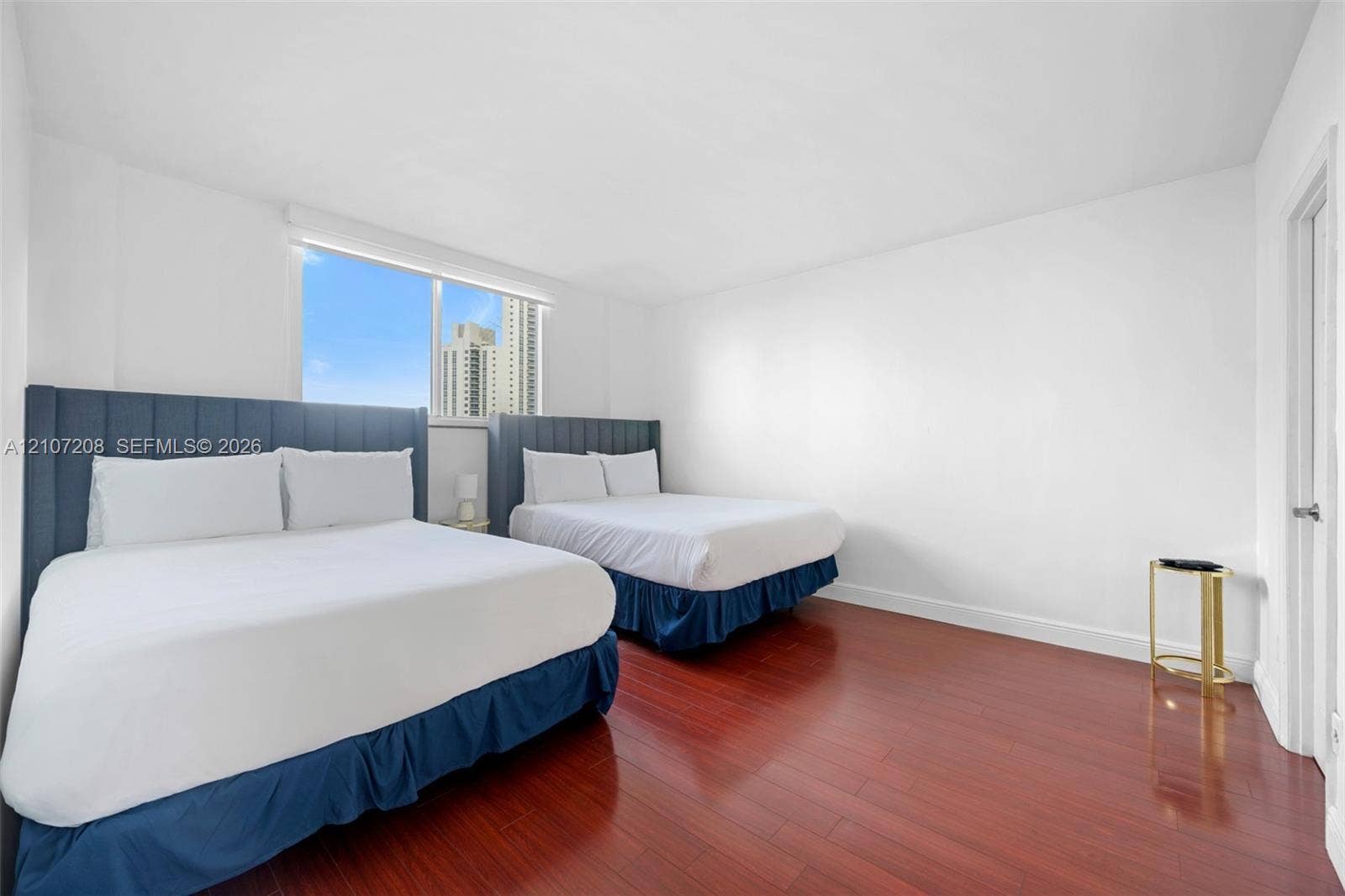 19370 Collins Avenue, #1405, Sunny Isles Beach, Sunny Isles Beach, FL 33160 Room featuring wood-finish flooring, large window, and neutral walls