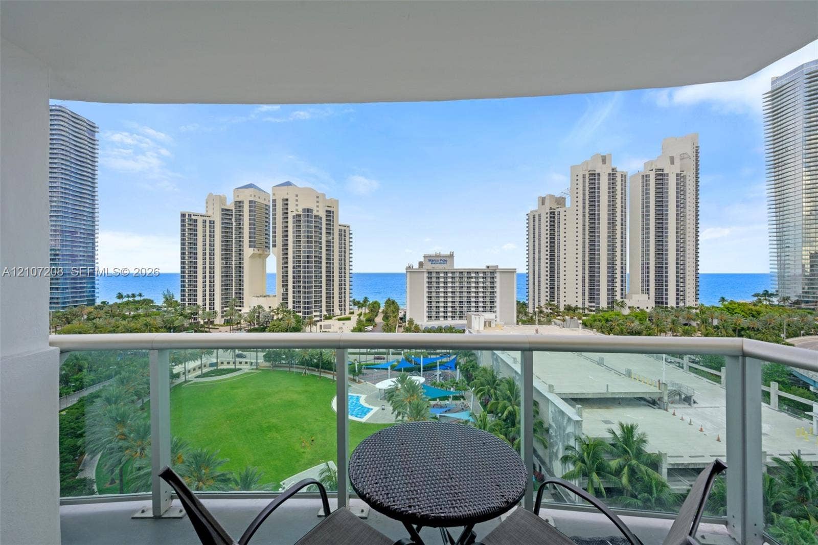 19370 Collins Avenue, #1405, Sunny Isles Beach, Sunny Isles Beach, FL 33160 Covered balcony with glass panel railing and ocean scenery