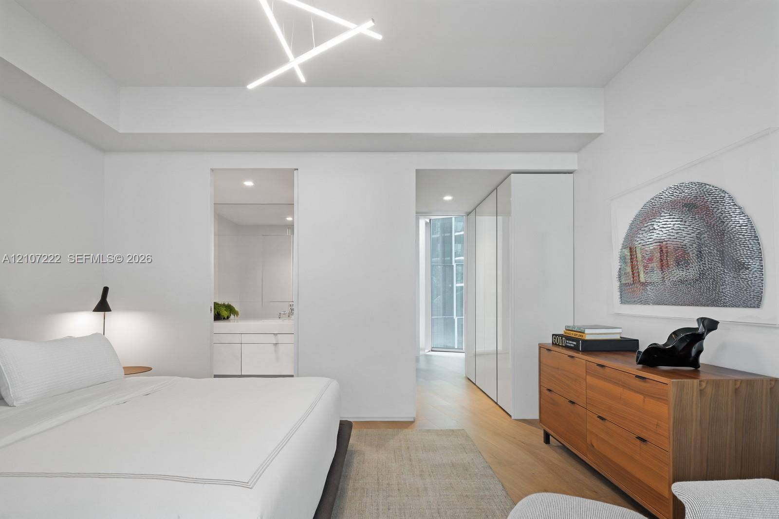 1300 Monad Terrace, #2F, Miami Beach, FL 33139 Geometric LED ceiling light fixture, wood-finish flooring, and built-in floor-to-ceiling cabinetry