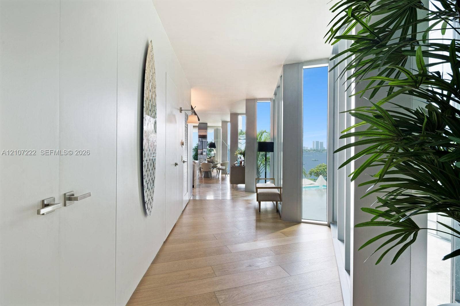 1300 Monad Terrace, #2F, Miami Beach, FL 33139 Hallway featuring wood-finish flooring, floor-to-ceiling windows, and flush-mounted cabinetry