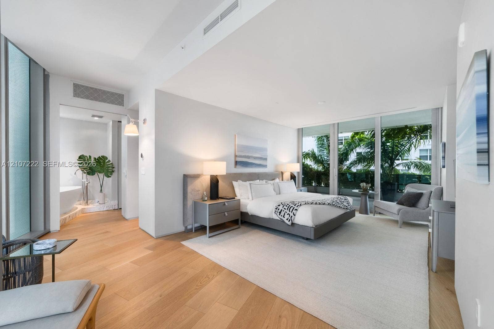 1300 Monad Terrace, #2F, Miami Beach, FL 33139 Floor-to-ceiling glass windows, wide-plank wood-finish flooring, recessed lighting, and a freestanding soaking tub