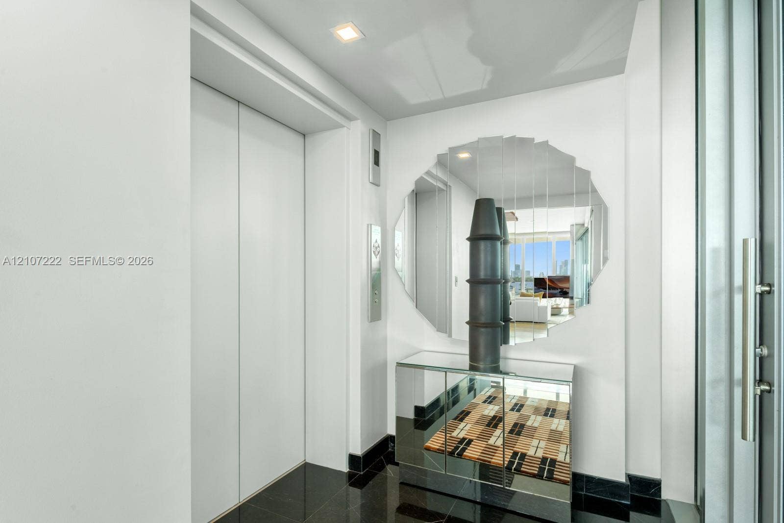 1300 Monad Terrace, #2F, Miami Beach, FL 33139 Private elevator entry with double-panel doors, high-gloss stone flooring, and recessed ceiling lighting